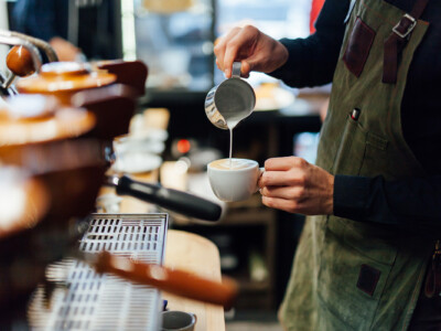 Barista making cappuccino, bartender preparing coffee drink